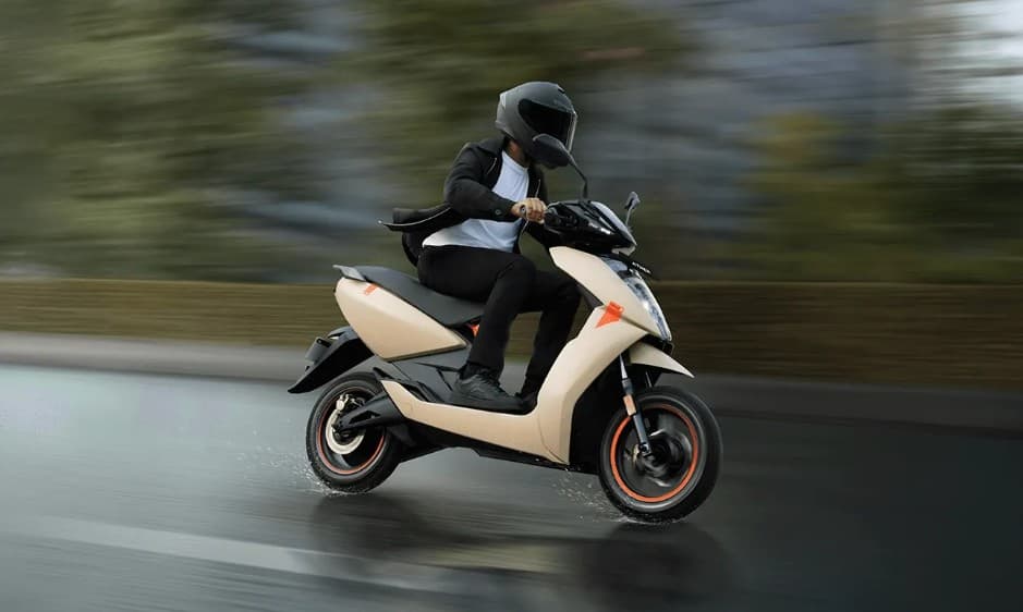 Looking over the sleek Ather 450X at a busy Bangalore junction